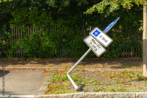 Damaged bent and dented metal traffic sign photo