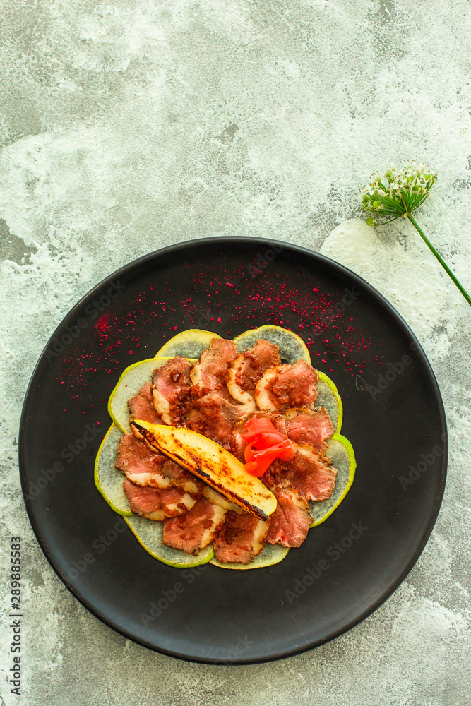 carpaccio meat duck and pear (savory snack, gourmet cuisine) menu concept. food background. copy space. Top view carpaccio meat duck and pear (savory snack, gourmet cuisine) menu concept. food background. copy space. Top view