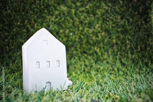 Model house on the grass background.Finance and Home Loan Concept.