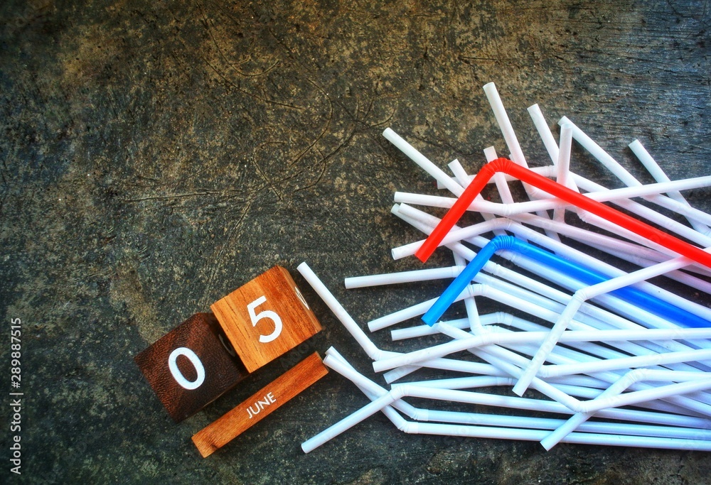Wooden calendar, 5 June, on a cement and straws background.World environment day.Concept No plastic,Zero - Waste Plastic,Pollution and Environment. Wooden calendar, 5 June, on a cement and straws background.World environment day.Concept No plastic,Zero - Waste Plastic,Pollution and Environment.