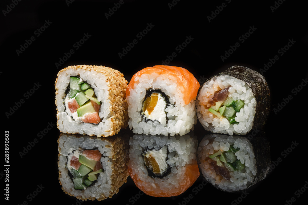 Set of sushi and maki rolls on the glass table Set of sushi and maki rolls on the glass table