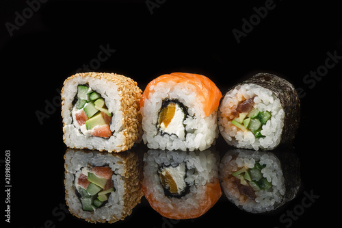 Set of sushi and maki rolls on the glass table