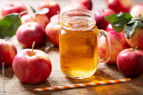 glass jar of apple juice with fresh fruits