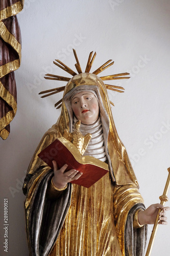 Saint Scholastica, altar statue in the church of St. Agatha in Schmerlenbach, Germany photo