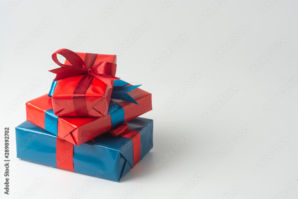 Blue and red gift boxes isolated over white background. Christmas, party or birthday concept. Copy space. Blue and red gift boxes isolated over white background. Christmas, party or birthday concept. Copy space.