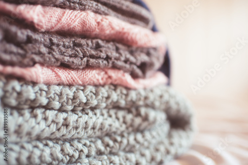 Colorful knitted clothes floded closeup. Winter season. Selective focus. photo