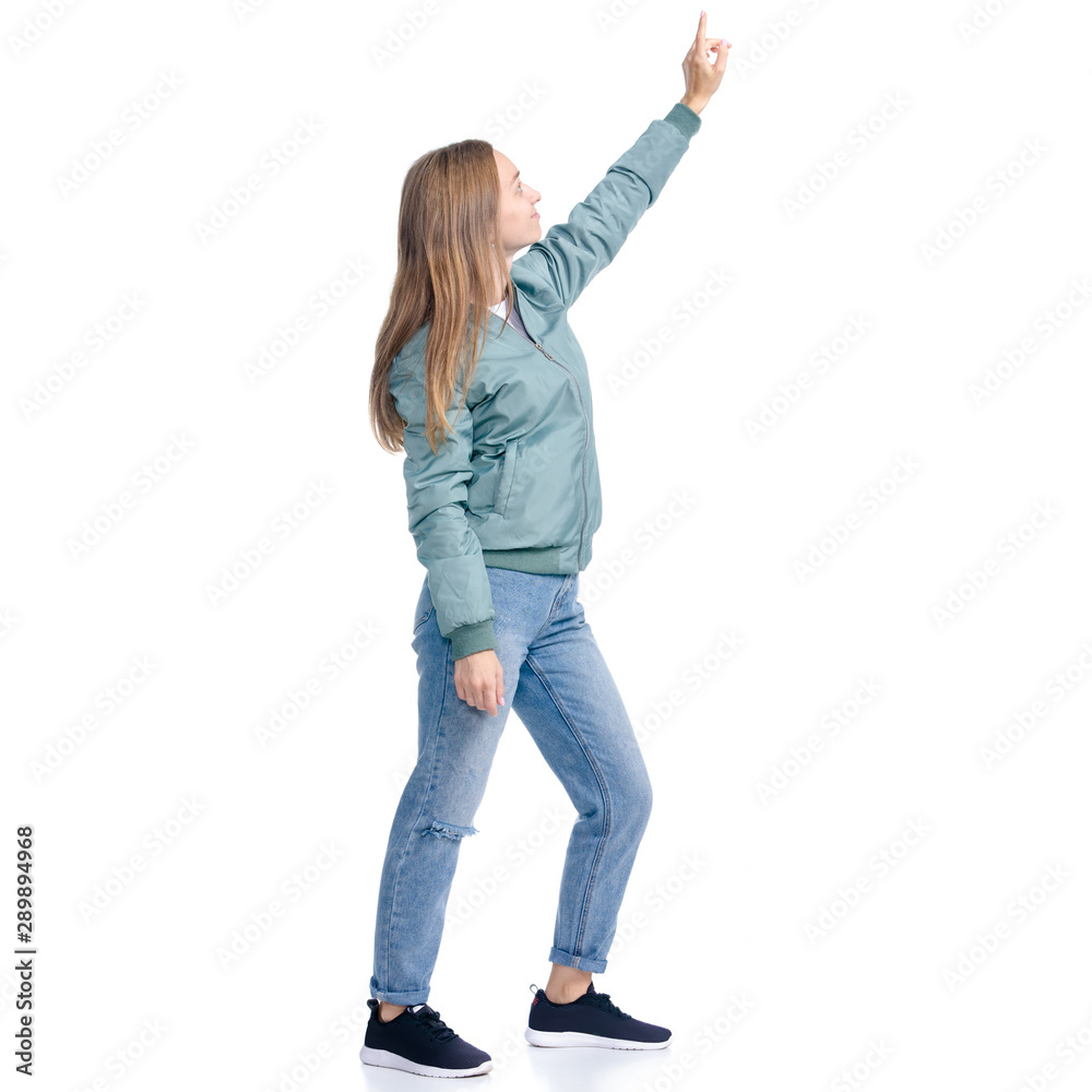 Woman in jeans coat jacket casual clothing standing smiling showing pointing on white background isolation Woman in jeans coat jacket casual clothing standing smiling showing pointing on white background isolation