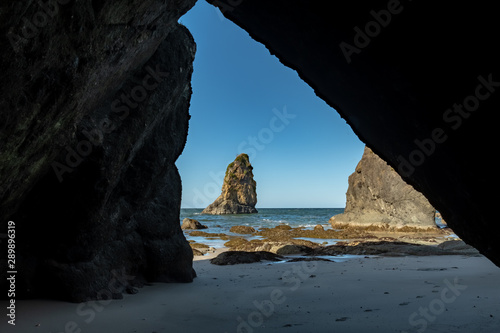 Peeking Out at Seastacks from Cave © kellyvandellen