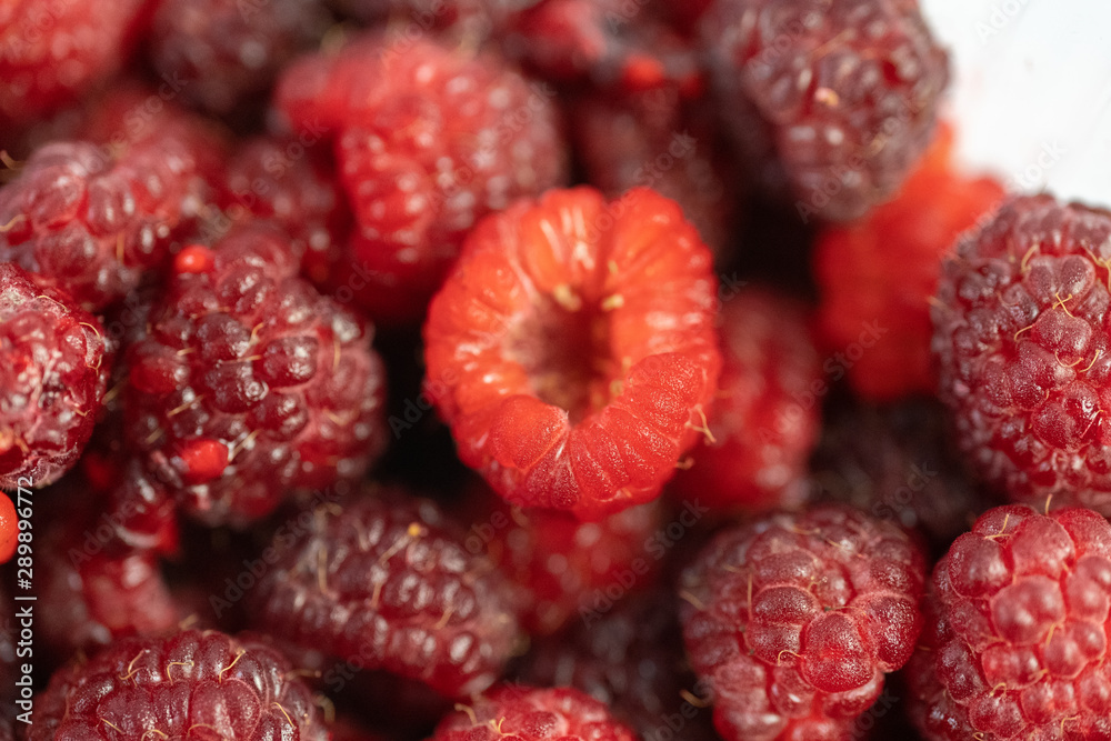 A lot of fresh raspberries on a white background A lot of fresh raspberries on a white background