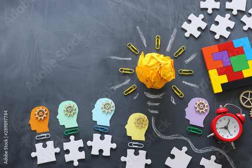Education concept image. Creative idea and innovation. Crumpled paper as lightbulb metaphor over blackboard photo