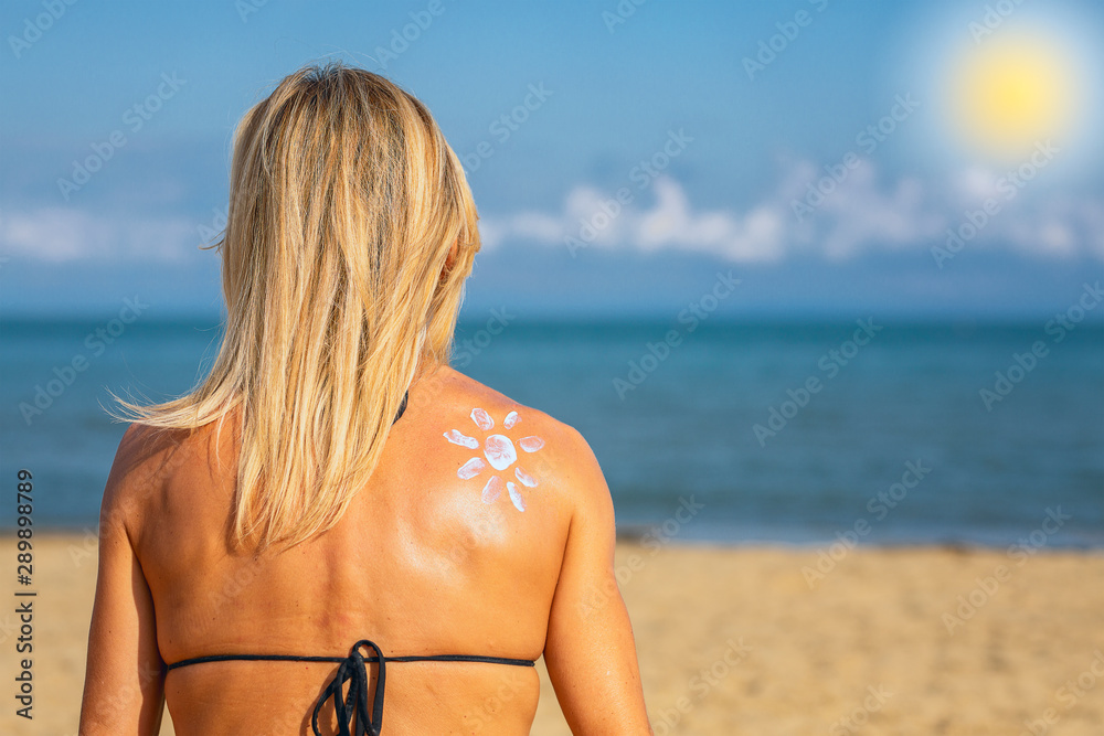 Fototapeta premium Woman with sun-shaped cream