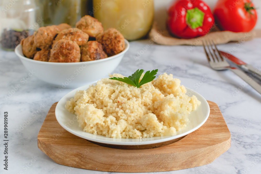 Couscous on plate served with homemade pork meatballs Couscous on plate served with homemade pork meatballs