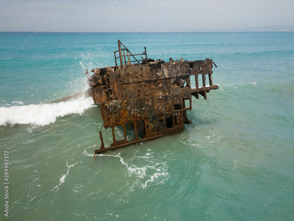 Rusty ship wreck surrounded by green sea, Cyprus
