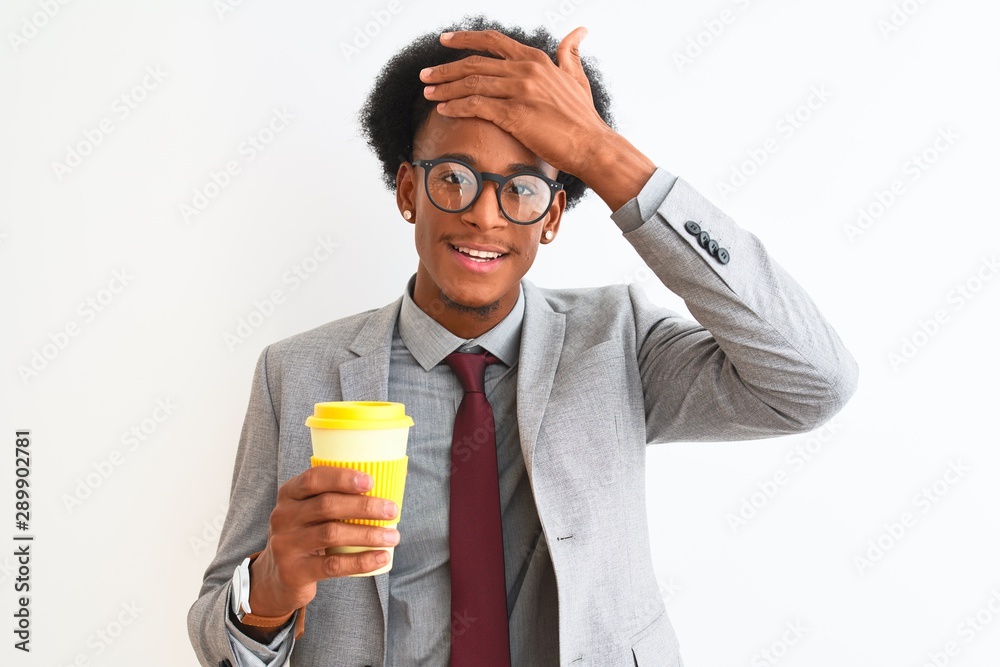African american businessman drinking cup of coffee over isolated white background stressed with hand on head, shocked with shame and surprise face, angry and frustrated. Fear and upset for mistake. African american businessman drinking cup of coffee over isolated white background stressed with hand on head, shocked with shame and surprise face, angry and frustrated. Fear and upset for mistake.