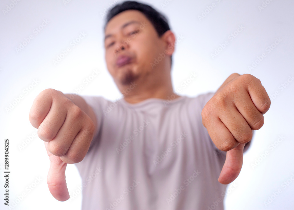 Young Man Showing Thumbs Down Young Man Showing Thumbs Down