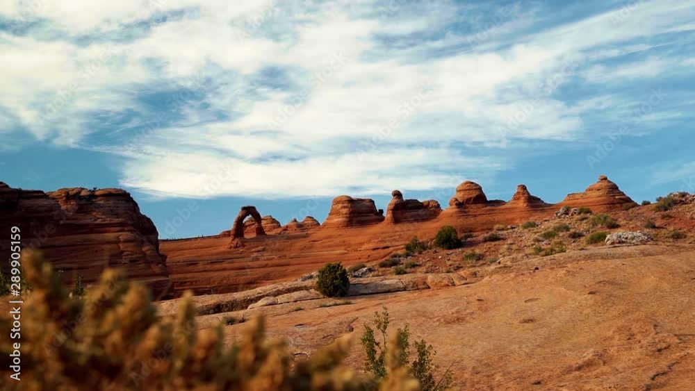Famous delicate arch on a gorgeous warm summer day from the Arches lookout hike in Moab, Utah. Famous delicate arch on a gorgeous warm summer day from the Arches lookout hike in Moab, Utah.