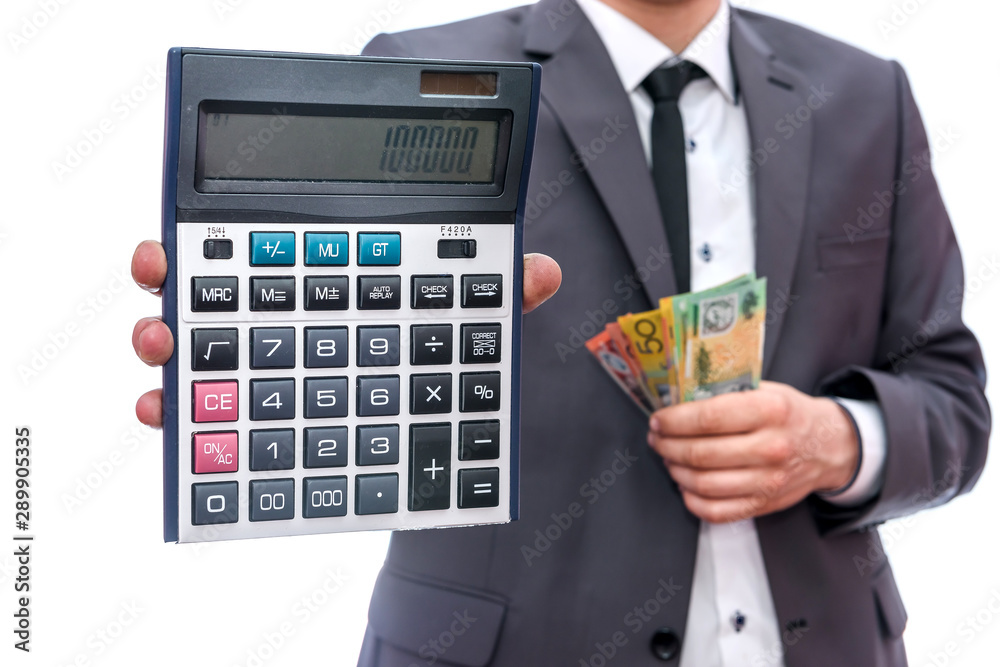 Man in suit holding australian dollars and calculator isolated on white Man in suit holding australian dollars and calculator isolated on white