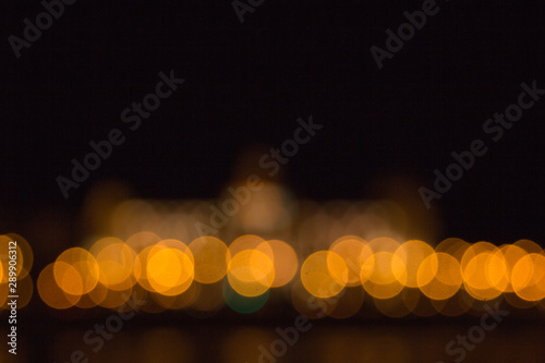 blurry lights of a big city at night. Background for travel photos. bokeh advertising poster © Yuliia