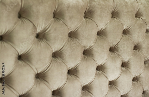 Luxury velour quilted sofa upholstery with buttons, elegant home decor texture and background