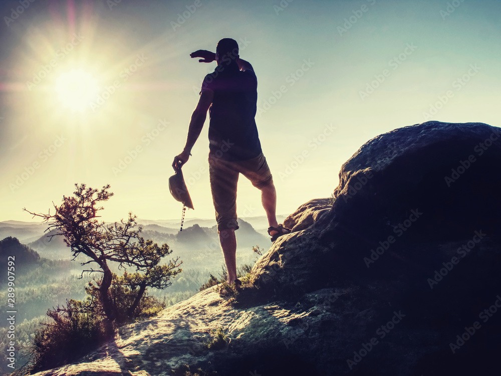 Trekker in cowboy hat on mountain with Sunrise enjoy view Trekker in cowboy hat on mountain with Sunrise enjoy view