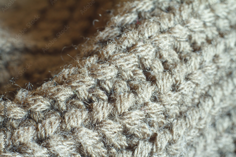 Extreme close-up olive color knitted sweater made of natural wool texture, wavy folds, selective focus