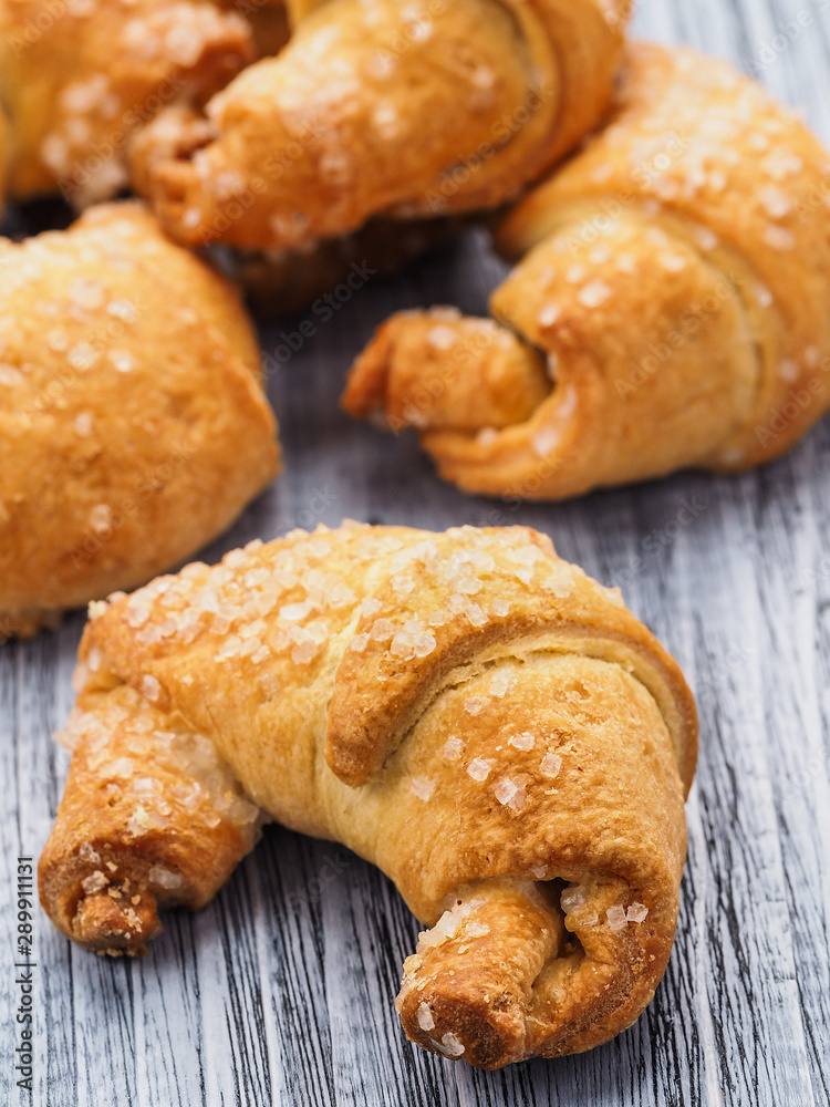 Tasty homemade croissants cake on the wooden