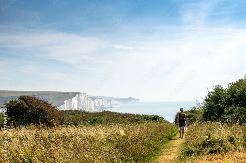 Woman on a footpath at Seven Sisters White Cliffs, England