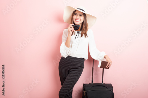 Beautiful traveler woman is exciting in pink background