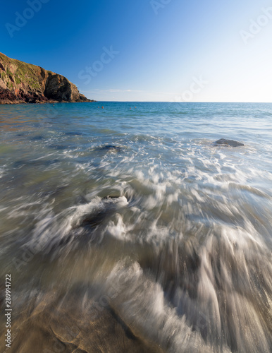 Breaking waves on Caerfai Beach, Pembrokeshire during summer photo