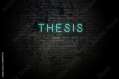 Картината върху платно Highlighted brick wall with neon inscription thesis