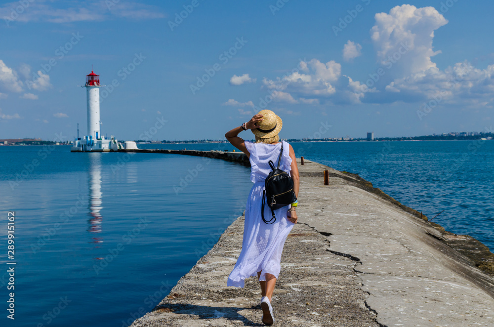 Young girl walking near the lighthouse
