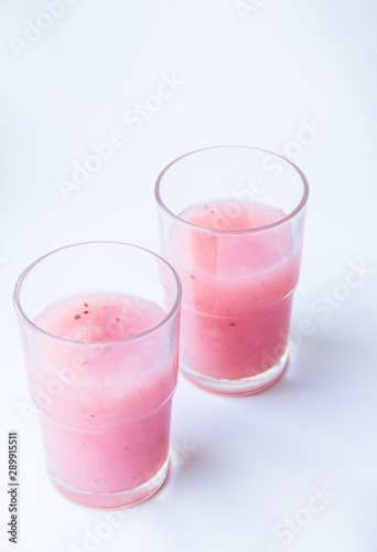 Drinking yogurt in a glass on a white background  copy space. Delicious pink fruit yogurt. Natural detoxification. Healthy eating concept. Fresh homemade yogurt for Breakfast. Fruit yogurt smoothie.
