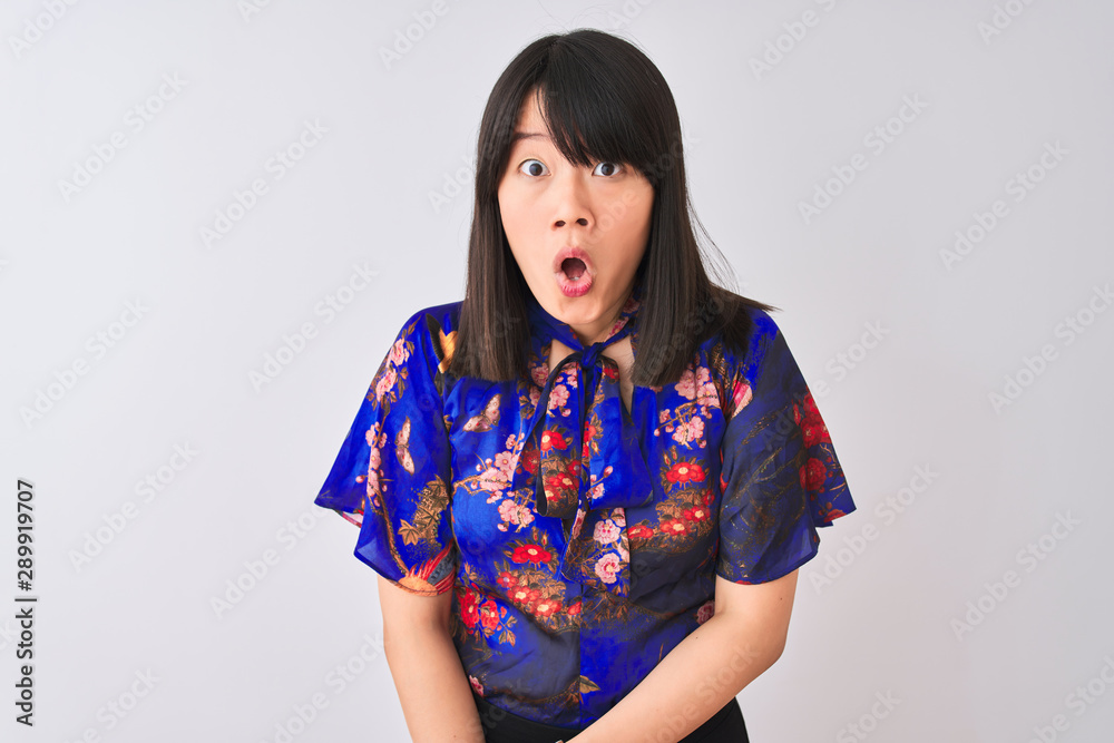 Young beautiful chinese woman wearing summer floral t-shirt over isolated white background afraid and shocked with surprise expression, fear and excited face. Young beautiful chinese woman wearing summer floral t-shirt over isolated white background afraid and shocked with surprise expression, fear and excited face.