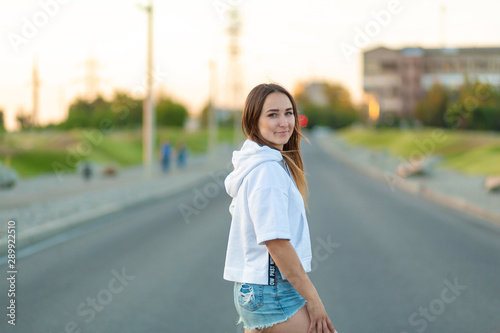 Young hipster girl posing with longboard, skateboard, street photo, life style, freedom, happy face,Beautiful young girl with tattoos riding longboard in sunny weather © Kate