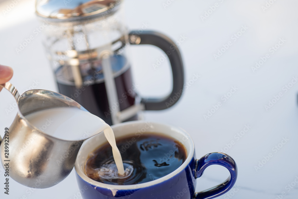 coffee, creamer and a coffee press coffee, creamer and a coffee press