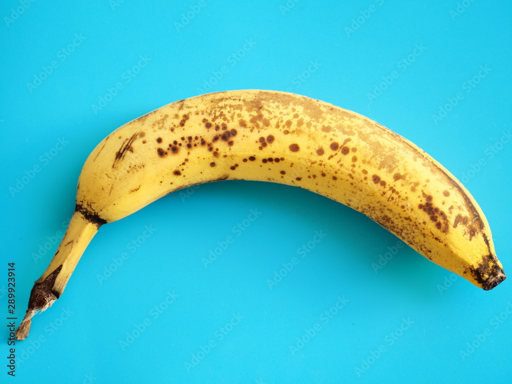 bright yellow banana on blue background