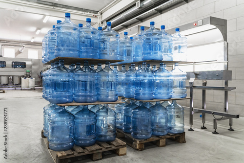 Water factory. Pallets with plastic bottle or gallon inside workshop interior