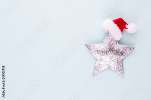 Christmas star, decor on pastel colored background. Christmas or New Year minimal concept. © gitusik
