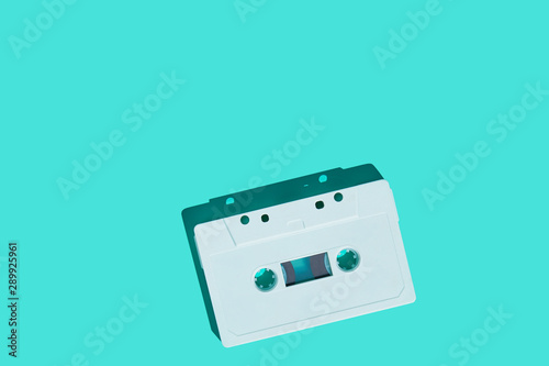 Audio cassette on colored background. White audio cassette tape. Vintage disco poster. Pattern of audio cassete