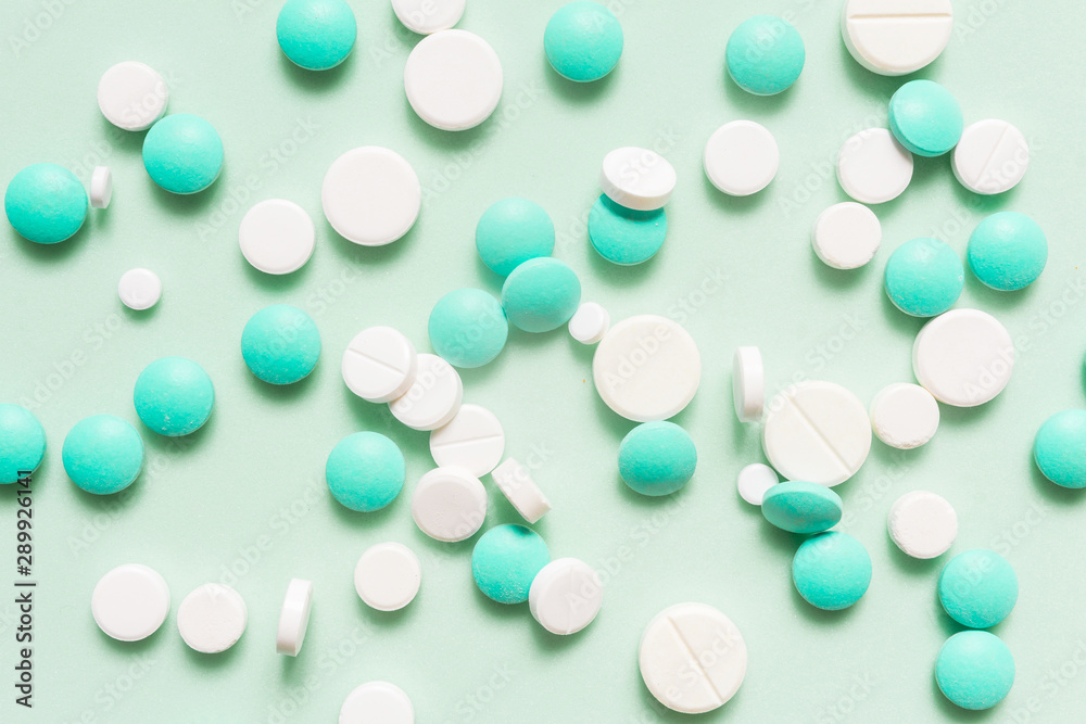Turquoise, cyan, neo mint colorful chocolate candies isolated on neo mint background. Heap of candies multi colored against a neo mint texture. Top view or flat lay. Color of the year 2020. Main trend Turquoise, cyan, neo mint colorful chocolate candies isolated on neo mint background. Heap of candies multi colored against a neo mint texture. Top view or flat lay. Color of the year 2020. Main trend