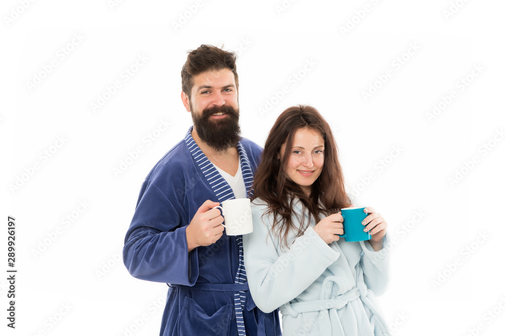 Caffeine power concept. Couple enjoy lazy weekend and drink coffee. Wife and husband bathrobes hold tea mug coffee cup. With coffee morning tastes better. Couple relax in morning with coffee Caffeine power concept. Couple enjoy lazy weekend and drink coffee. Wife and husband bathrobes hold tea mug coffee cup. With coffee morning tastes better. Couple relax in morning with coffee