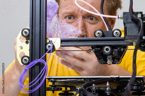 Man fighting with a 3D printer