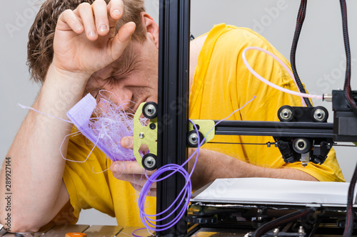 Man fighting with a 3D printer