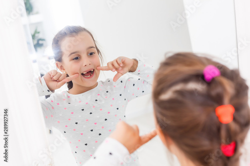 little girl smiling mirror teeth