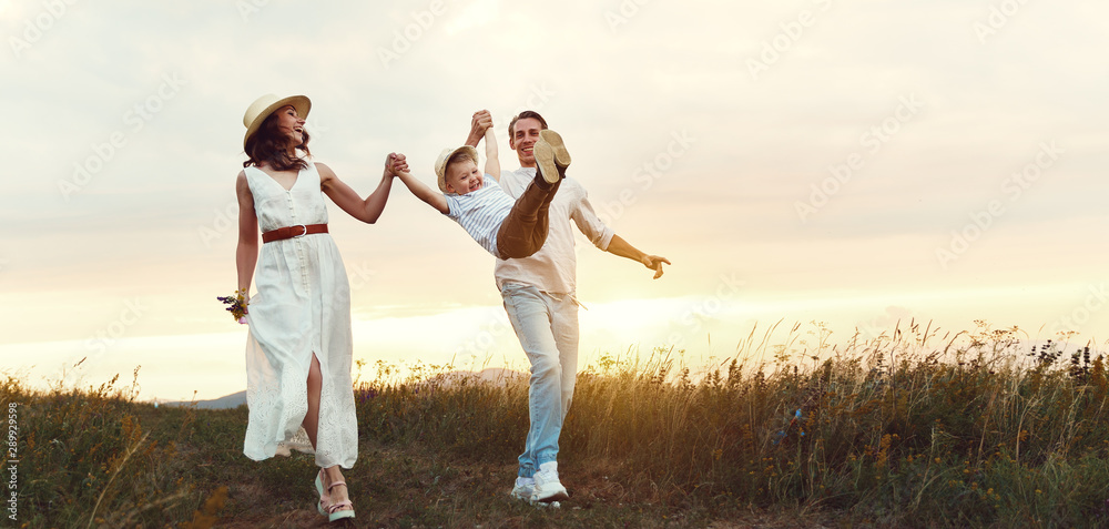 Happy family father of mother and child son on nature at sunset Happy family father of mother and child son on nature at sunset