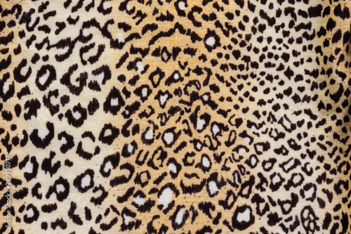 Background in the form of a knitwear product with a pattern similar to a leopard skin in cream brown tones
