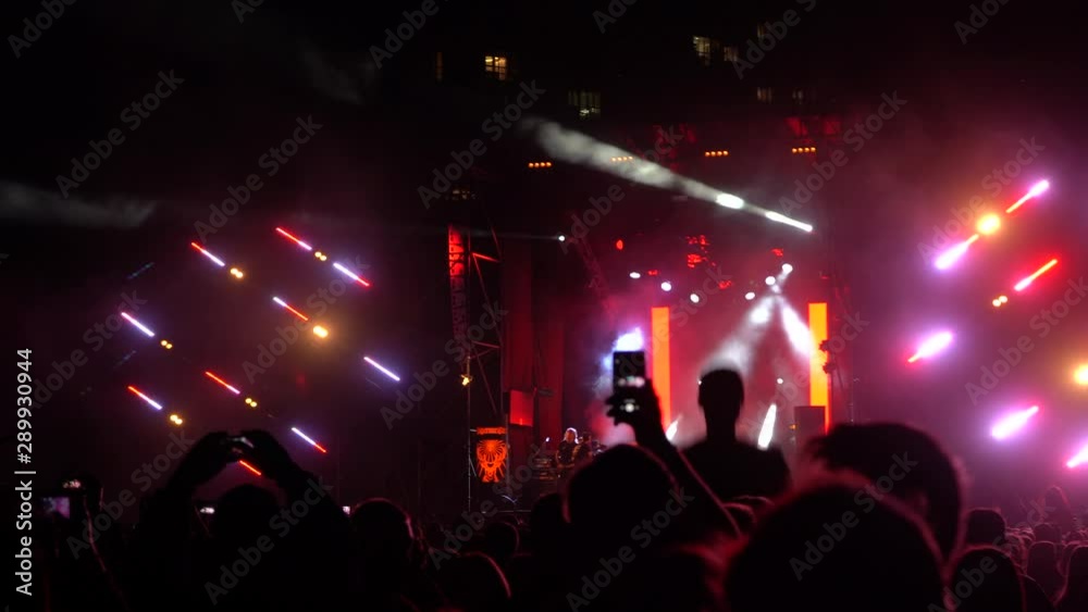 Kiev, Ukraine, Europe - September 15, 2019: Many spectators in front of the stage waving their hands. Open air music festival 