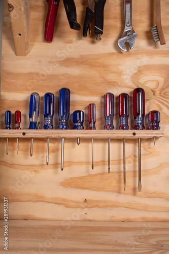 Screwdriver Set in an Organized Rack in a Workbench of Tools