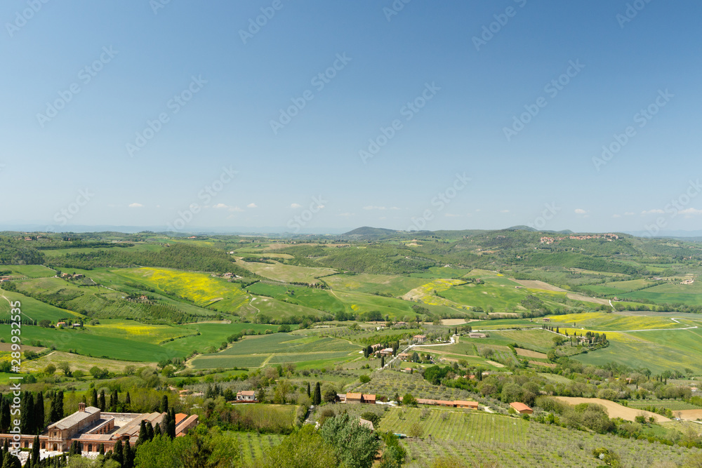 Tuscan countryside with farms and green grass, as seen from above Tuscan countryside with farms and green grass, as seen from above