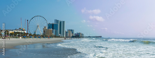 Panoramic view of Myrtle Beach, South Carolina with beach, hotels, ferris wheel, and boardwalk.